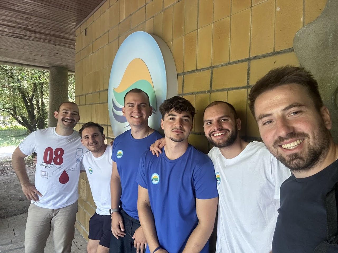 Six MARBLE students and team members smiling in front of the MARBLE logo